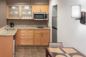 a small kitchen with a sink and a microwave at Trellis Durham RTP in Durham