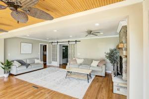 a living room with a couch and a table at NEW! Lake Winnebago Waterfront Retreat in Oshkosh