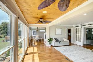 a living room with a ceiling fan and a couch at NEW! Lake Winnebago Waterfront Retreat in Oshkosh +18 photos