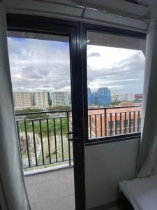 a room with a window with a view of a city at Shore 2 Tower 2 Staycation in Manila