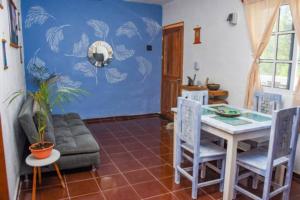 a living room with a table and a couch at Departamento cerca del Ferry y del centro de Holbox in Holbox Island +13 photos