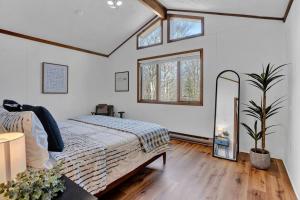 a bedroom with a bed and a mirror in it at Serene & Fun Family Gem ~ Big Bass Lake Community! in Gouldsboro +35 photos