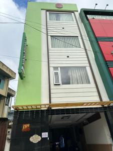 a green and white building with a sign on it at Bình Minh Motel Pleiku in Pleiku