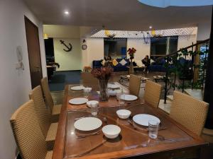 a dining room table with plates and bowls and chairs at Beach wave in Dubai