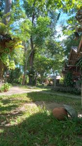 a park with trees and grass and a building at Bamboo Bungalow - Thong Nai Pan Yai in Thong Nai Pan Yai +4 photos