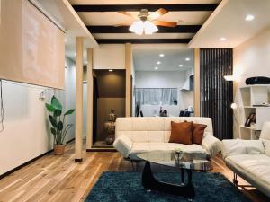 a living room with a white couch and a table at Designer Room Japan Residence-Namba in Osaka