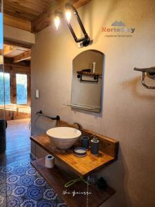 a bathroom with a sink and a mirror on the wall at Cabaña - El gran escape in Salta