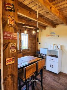 a kitchen with a table and a refrigerator at Cabaña - El gran escape in Salta