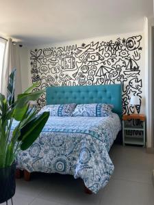 a bedroom with a blue bed with a black and white wall at Laguna del mar La Serena in La Serena +20 photos