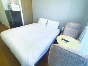 Letto o letti in una camera di BiBi Hotel Cosmos Shintoshin