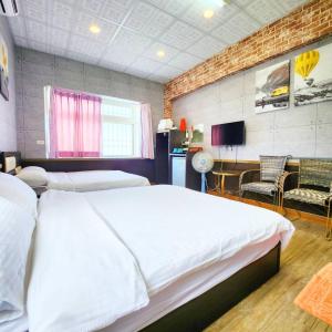 a bedroom with a bed and a table and chairs at Gajilia B&B in Chenggong