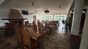 a dining room with wooden tables and chairs at Hotel Colonial Taxco in Taxco de Alarcón