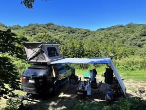 a truck with a camper on top of it at ぼっちの森 in Minamiizu