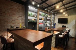 a bar with two tables and a tv in a room at 4B12B Bar 5 min City Center-no karaoke in Ipoh