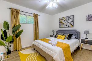 a bedroom with a large bed with a yellow blanket at 314 NEW 5BR Alamo River Walk Zoo SeaWorld SAT in San Antonio