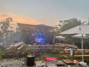 a restaurant with tables and a stage in the background at Homestay Mai Anh Đào in Da Thien