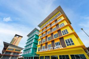 a building with a yellow and green building at Semporna Garden Hotel in Semporna