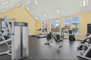 a gym with treadmills and chairs in a room at Cozy 2BR/2Bath Oasis 10 Minutes Away From Fort Lee in Brandermill