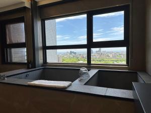 a bathroom with a bath tub with a large window at 幸福M&M House-龜山日出溫泉景觀宅 in Toucheng