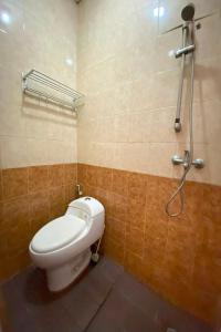 a bathroom with a toilet and a shower at OYO 92932 Guesthouse Marbella in Nongsa