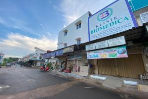 a building with a sign on the side of a street at OYO 92932 Guesthouse Marbella in Nongsa