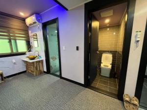 a bathroom with a toilet and a sink at Maldives Hotel & Hostel in Busan +26 photos