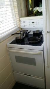 a kitchen with two pots on a stove at Cool, quiet ocean view 30 day min in Honolulu