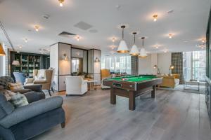 a living room with a pool table in it at Urban Rest Canary Wharf Apartments in London
