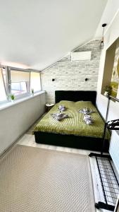 Un dormitorio con una cama con dos muñecas. en Чудові апартаменти «D.I.M.» в Старому місті, en Kamianets-Podilskyi