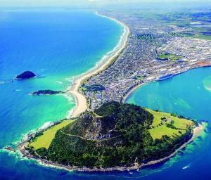 an aerial view of a small island in the ocean at Mount Beach Villa in Mount Maunganui