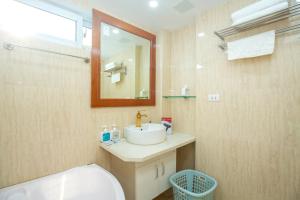 a bathroom with a sink and a toilet and a mirror at Sumitomo11 Apartment 5-39 Linh Lang in Hanoi