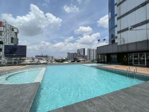 a large swimming pool on top of a building at The Bazaar Hotel Bangkok in Bangkok