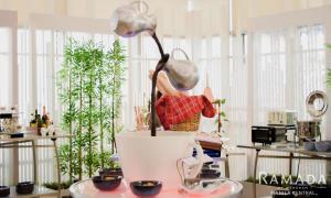 a statue of a woman in a pot on a table at Ramada by Wyndham Manila Central in Manila