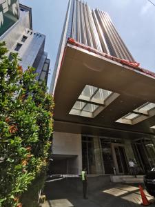 a man standing in front of a building at Warhol Residence Semarang Simpang Lima in Semarang
