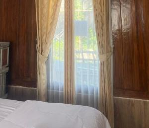 Кровать или кровати в номере Villa Jagung
