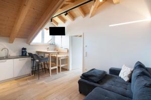 a living room with a couch and a table at Ferienwohnung Wendelsteinblick in Bad Tölz +18 photos