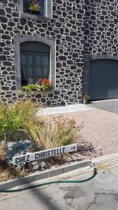 a street sign in front of a stone building at chez Christelle in Rochefort