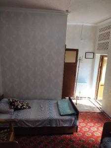 a bedroom with a bed in a room at Masturabonu Ravshan in Bukhara