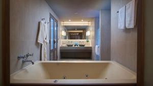 a large bath tub in a bathroom with a sink at Amari Vogue Krabi in Tab Kaek Beach