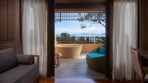 a living room with a view of a balcony at Amari Vogue Krabi in Tab Kaek Beach