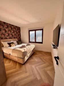 a bedroom with a bed and a flat screen tv at Penthouse Sarajevo in Sarajevo