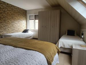 a bedroom with two beds and a attic at Nimary Logies in Heusden - Zolder