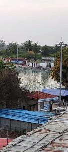 a marina with blue benches and a body of water at PGR Thirunallar in kāraikāl