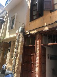 a building with a wooden door on a street at Lito Rooms in Chania Town +1 photo