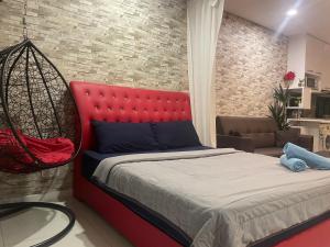 a bedroom with a red bed and a swing at Mercu Summer Suite KLCC Studio with Karaoke in Kuala Lumpur