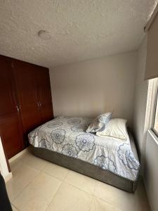 a bedroom with a bed with a dolphin pillow on it at Apartamento cómodo con excelente ubicación in Bucaramanga