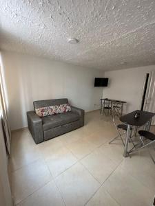 a living room with a couch and a table at Apartamento cómodo con excelente ubicación in Bucaramanga