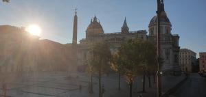 a large building with trees in front of it at Basilica Hotel in Rome