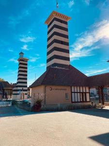 a building with two towers on top of it at La Deauvilloise YourHostHelper in Deauville
