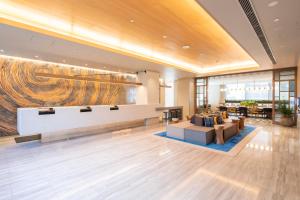 a lobby with a reception desk and a couch at Hotel Forza Nagoya Sakae in Nagoya